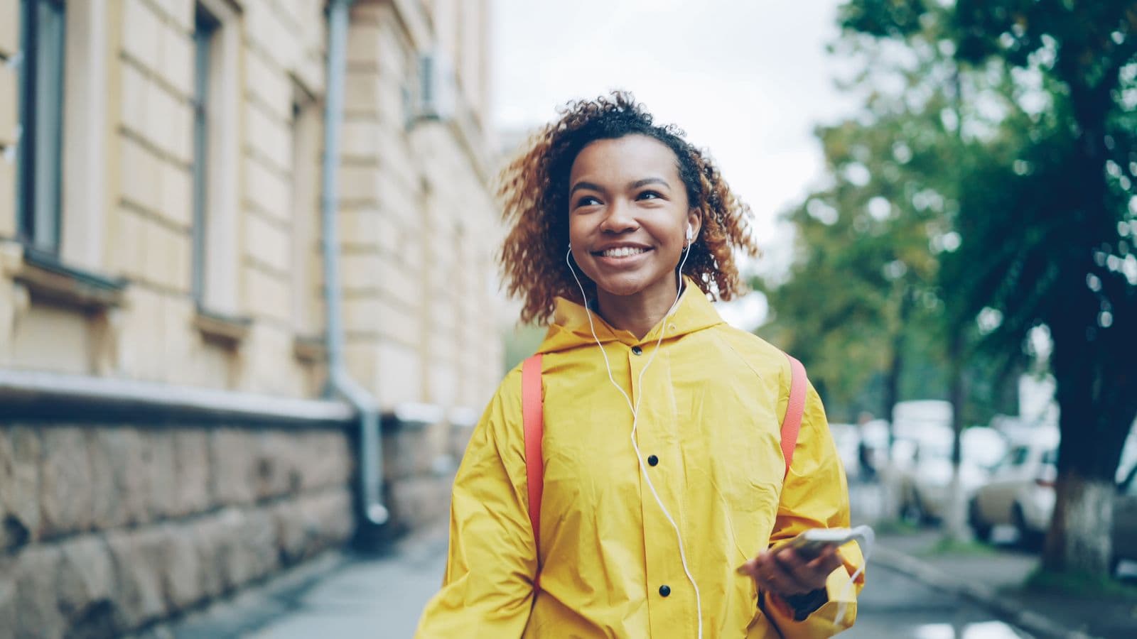 A woman walking through the city without a car